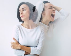 Female suffering from disorganized schizophrenia in sadness and anger