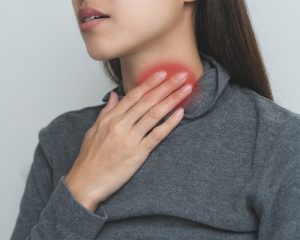 woman touching her neck affected by sore throat on one side