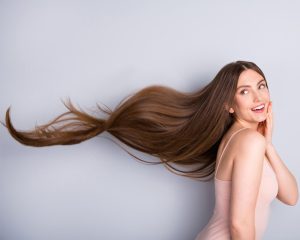 long hair female experiencing the signs of hair growth