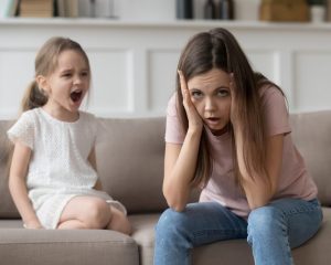 exhausted mother feeling desperate on screaming daughter